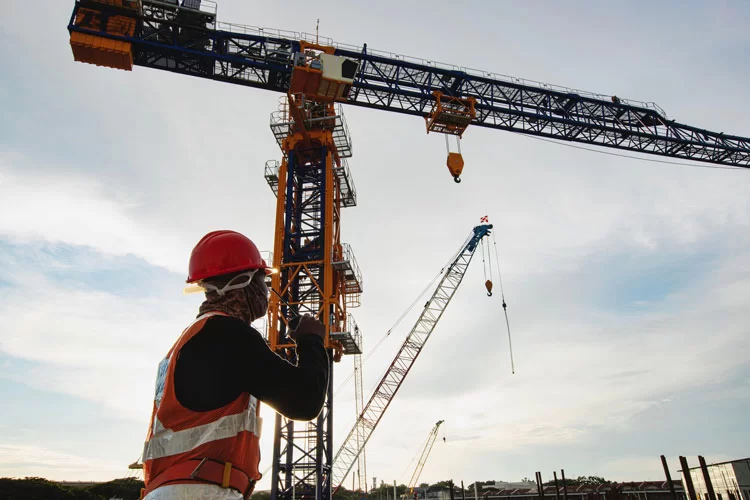 Man directing a crane during rigging