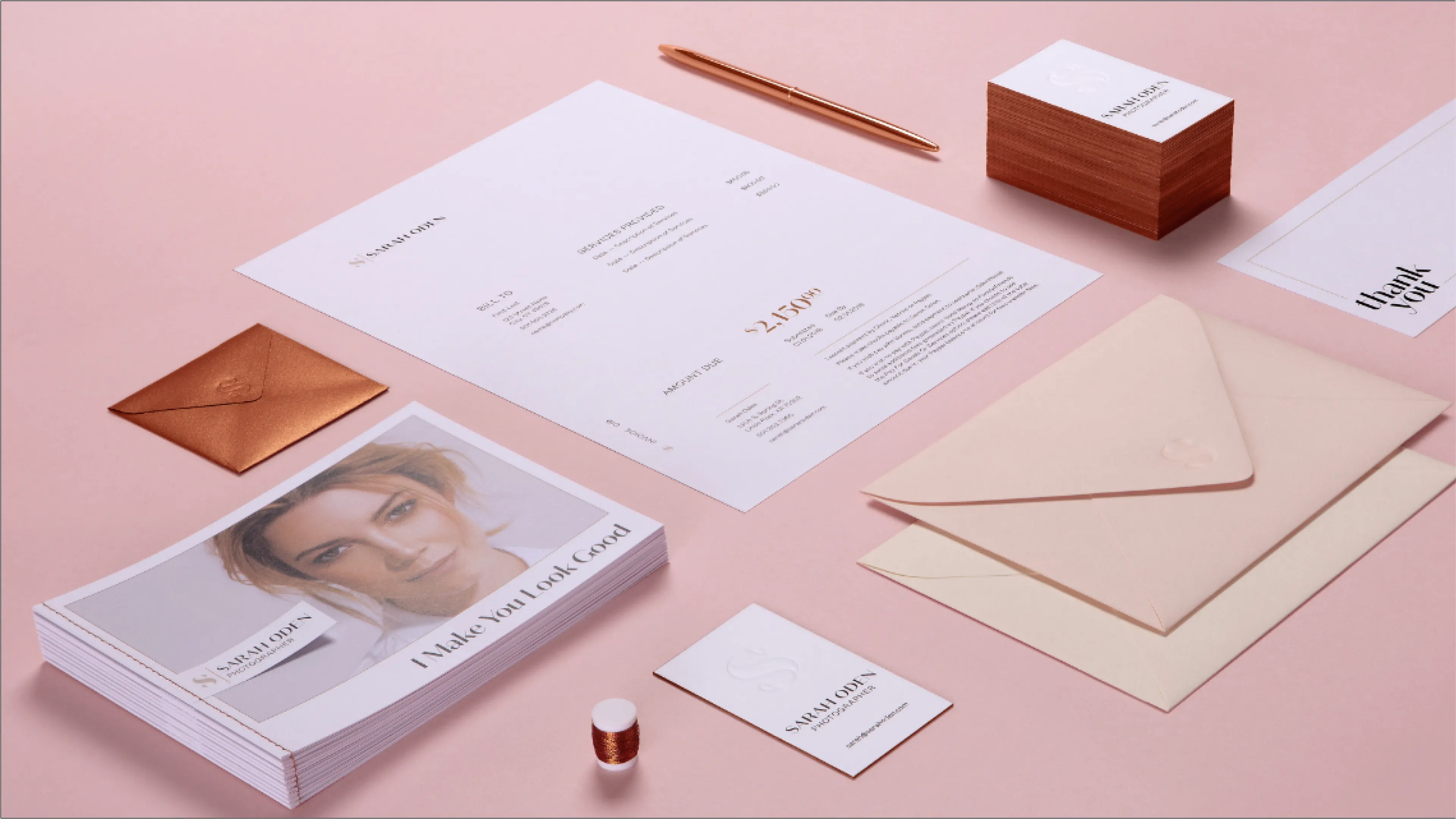Sarah Oden Photographer complete brand collateral flatlay on pink surface including invoice, business cards with copper edges, copper envelope, cream envelopes, promotional postcards, and thank you card, designed by Unbound Collective