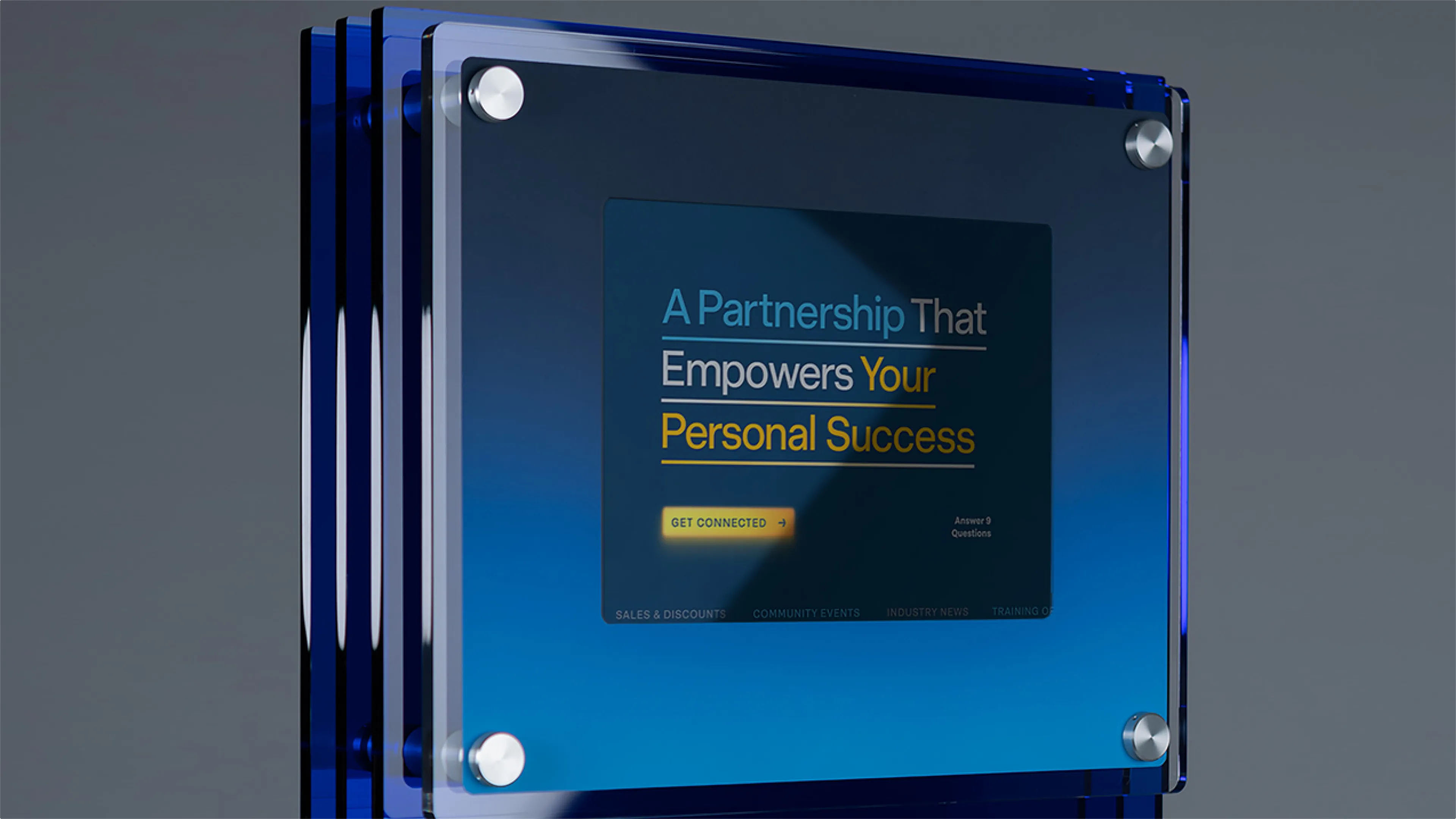 R&E Supply A Partnership That Empowers Your Personal Success dealer program web page displayed on angled blue acrylic kiosk display, web design by Unbound Collective
