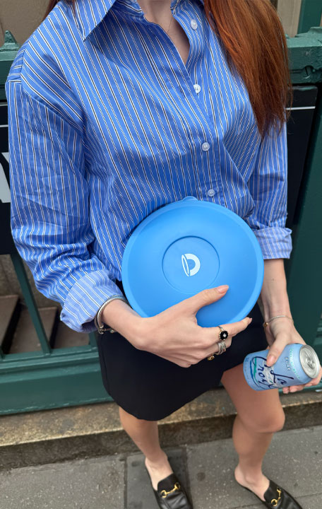 Woman in a blue outfit holding a reusable bowl