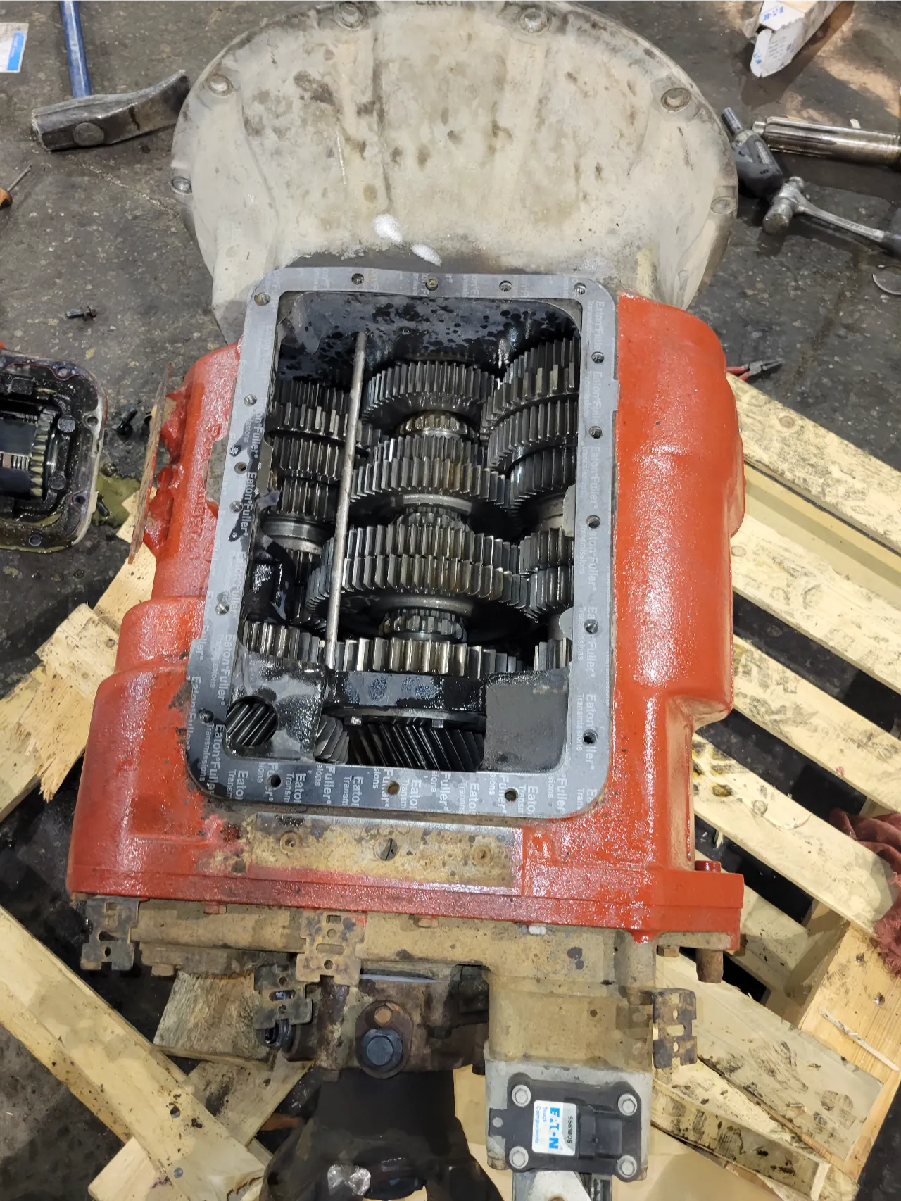 Disassembled Eaton transmission showing internal gear clusters during heavy-duty drivetrain repair.