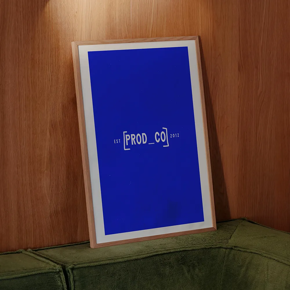Framed Prod Co Accountants wordmark in cobalt blue against a wood-paneled wall