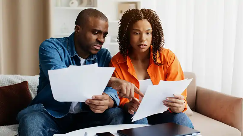 African American couple reviewing warranty coverage options.