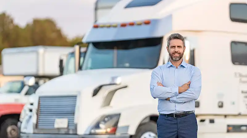 Insurance agent reviewing a commercial truck policy with an owner-operator.