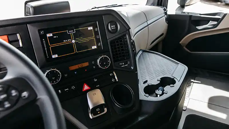 Electronic logging device mounted in a semi truck cab showing hours of service.