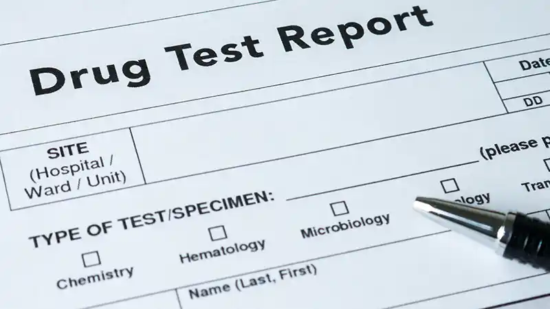 DOT Drug and Alcohol Testing Guide for Small Fleets Truck driver completing a DOT drug and alcohol test at a collection site.