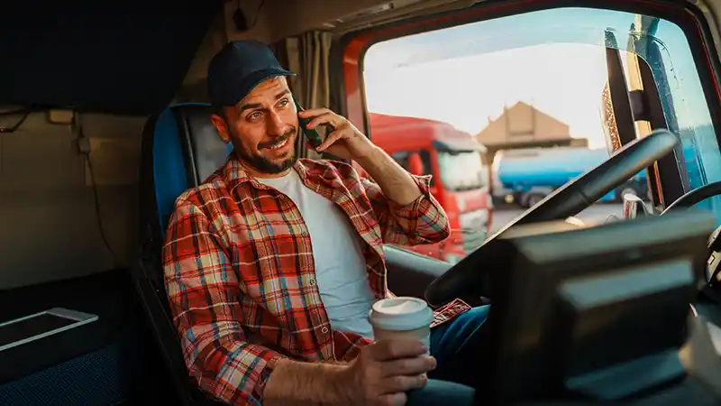 How to Find and Book Loads Without a Broker Owner-operator on the phone booking a direct load from a truck cab.