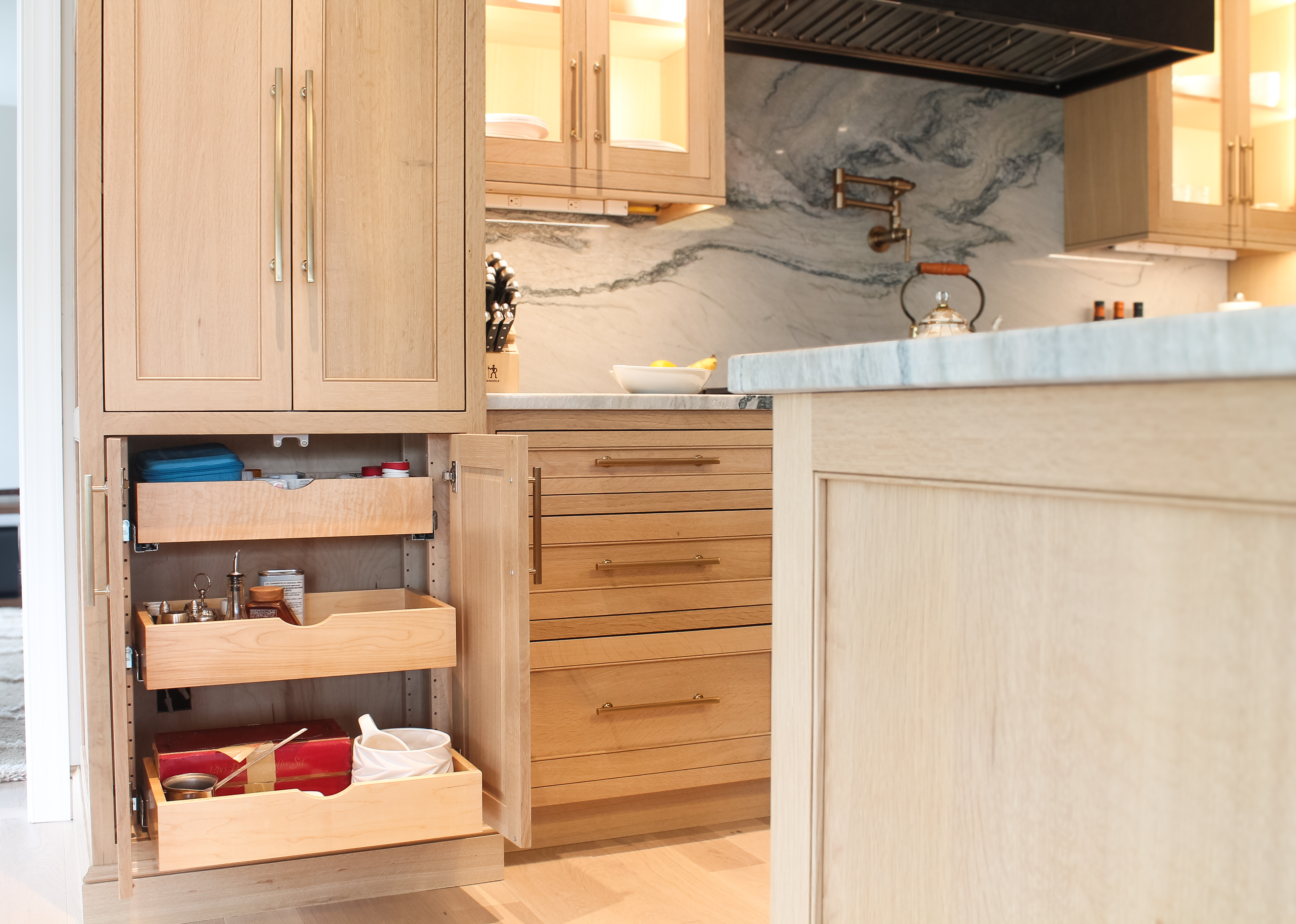 Pull-out storage bins inside a custom kitchen cabinet