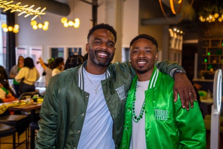 two men smile for a photograph