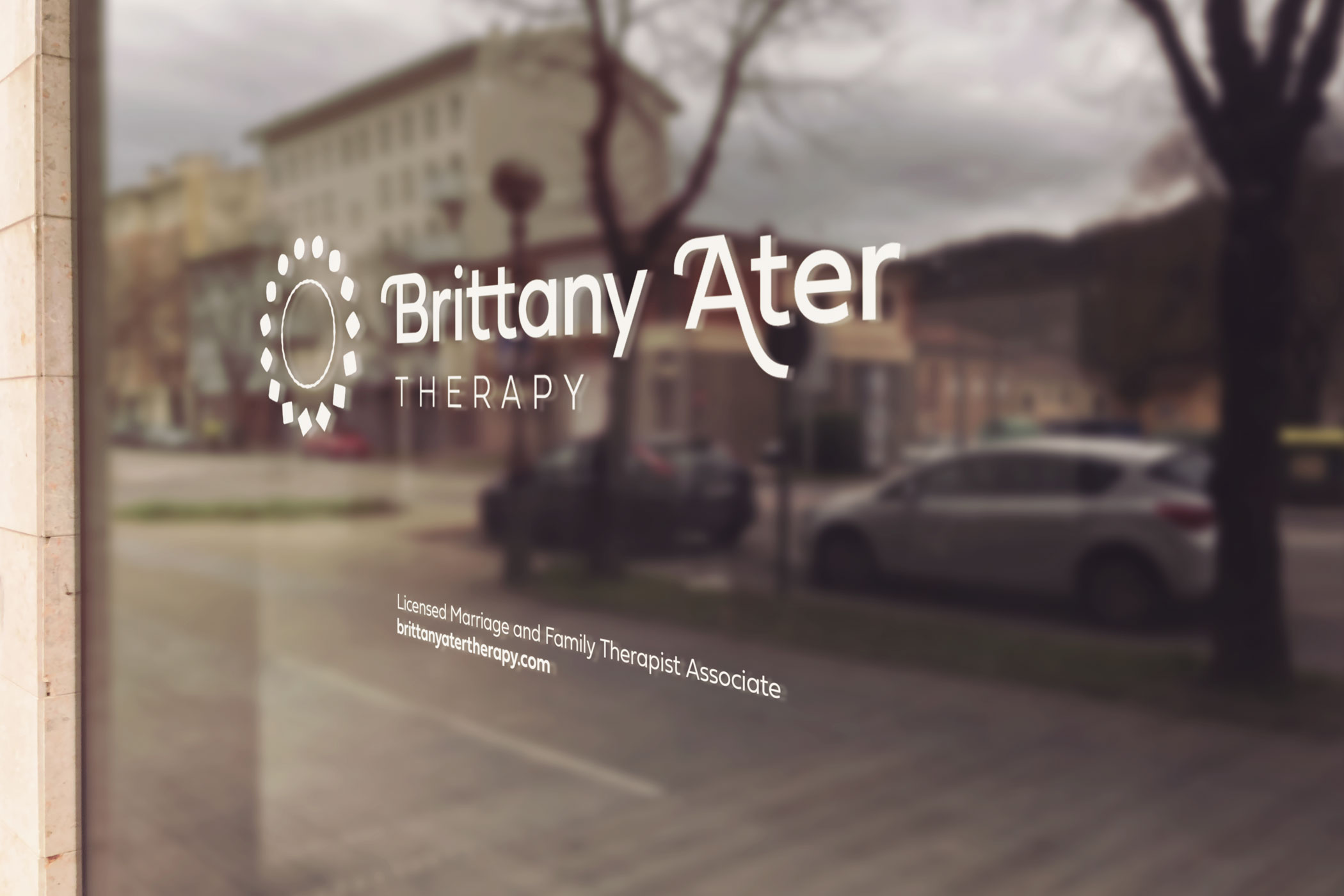Storefront window displaying the logo and text for Brittany Ater Therapy, Licensed Marriage and Family Therapist Associate.