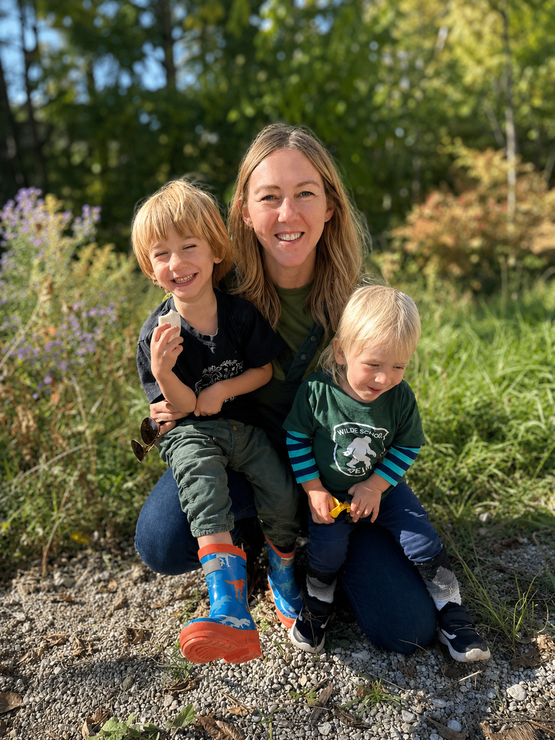 Melissa with two young children outdoors at Wilde School