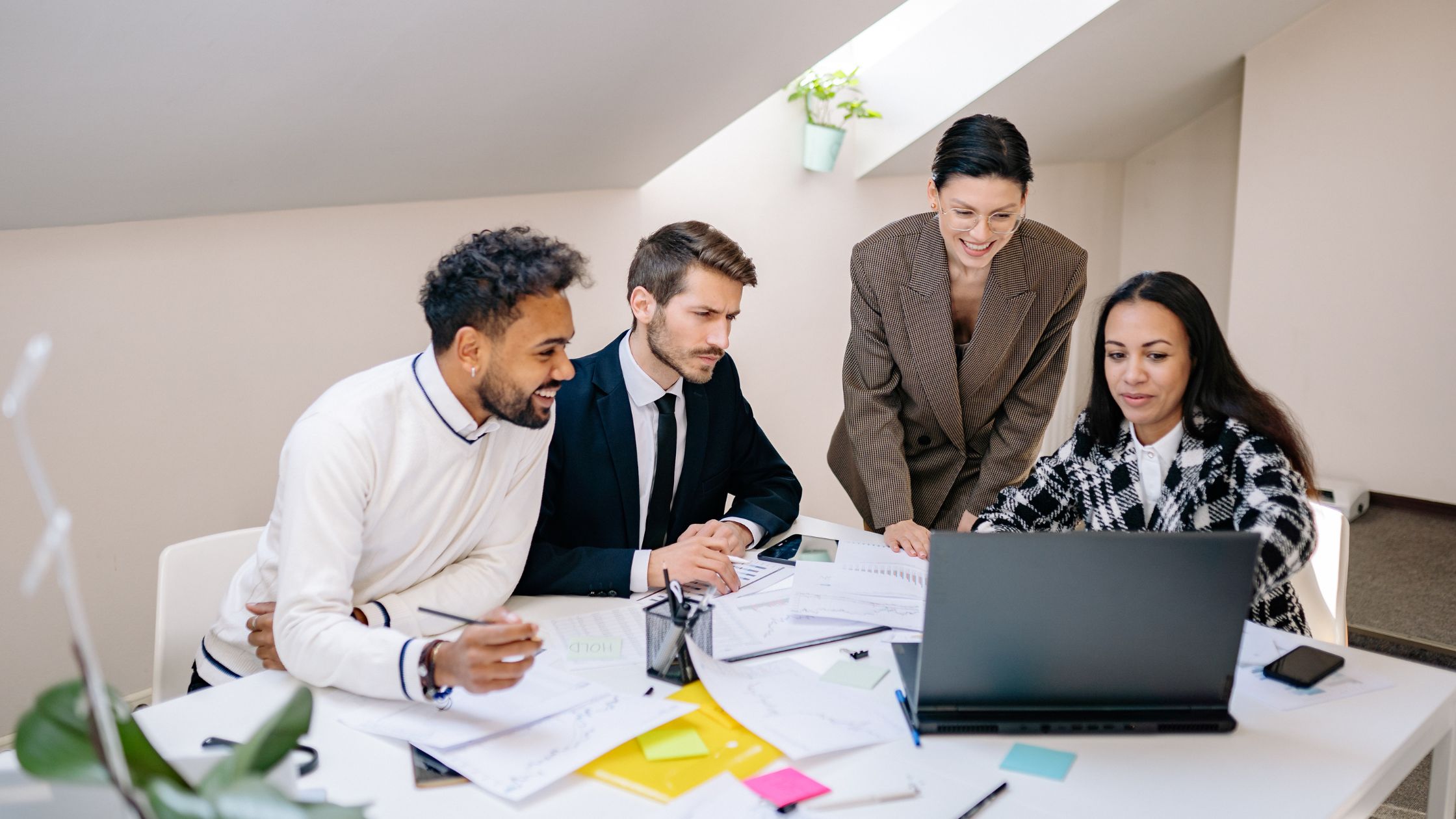 HR consultants workforce planning around a computer