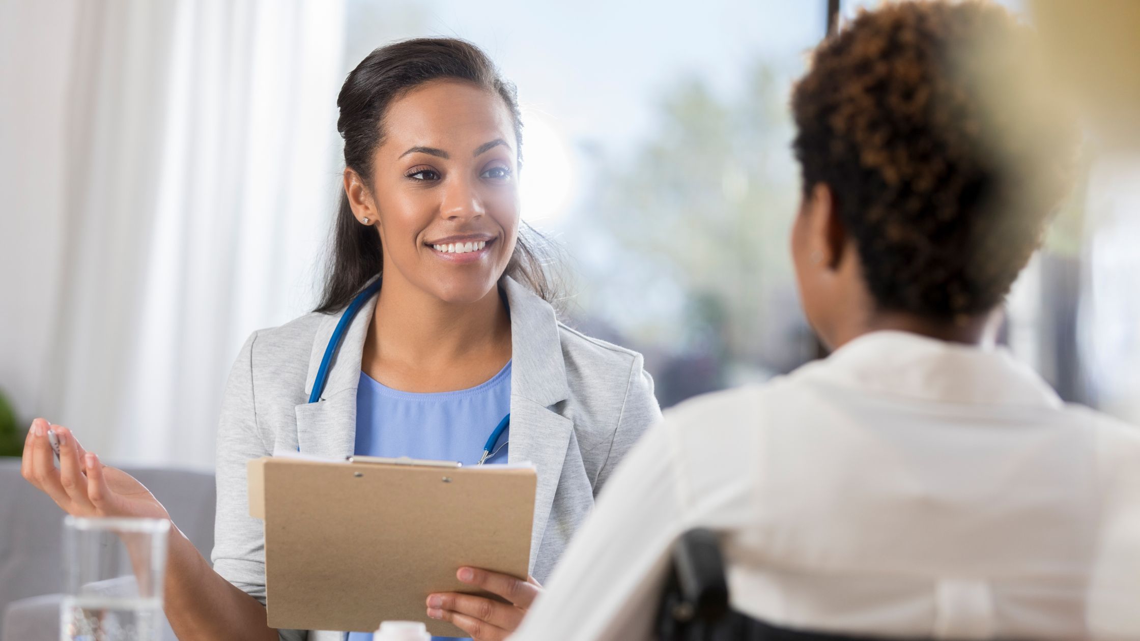 Mental health professional talks with adult woman