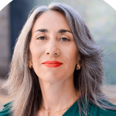 A woman with grey hair and red lipstick.