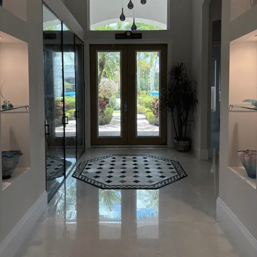 Shiny floors showing a reflection of the front door