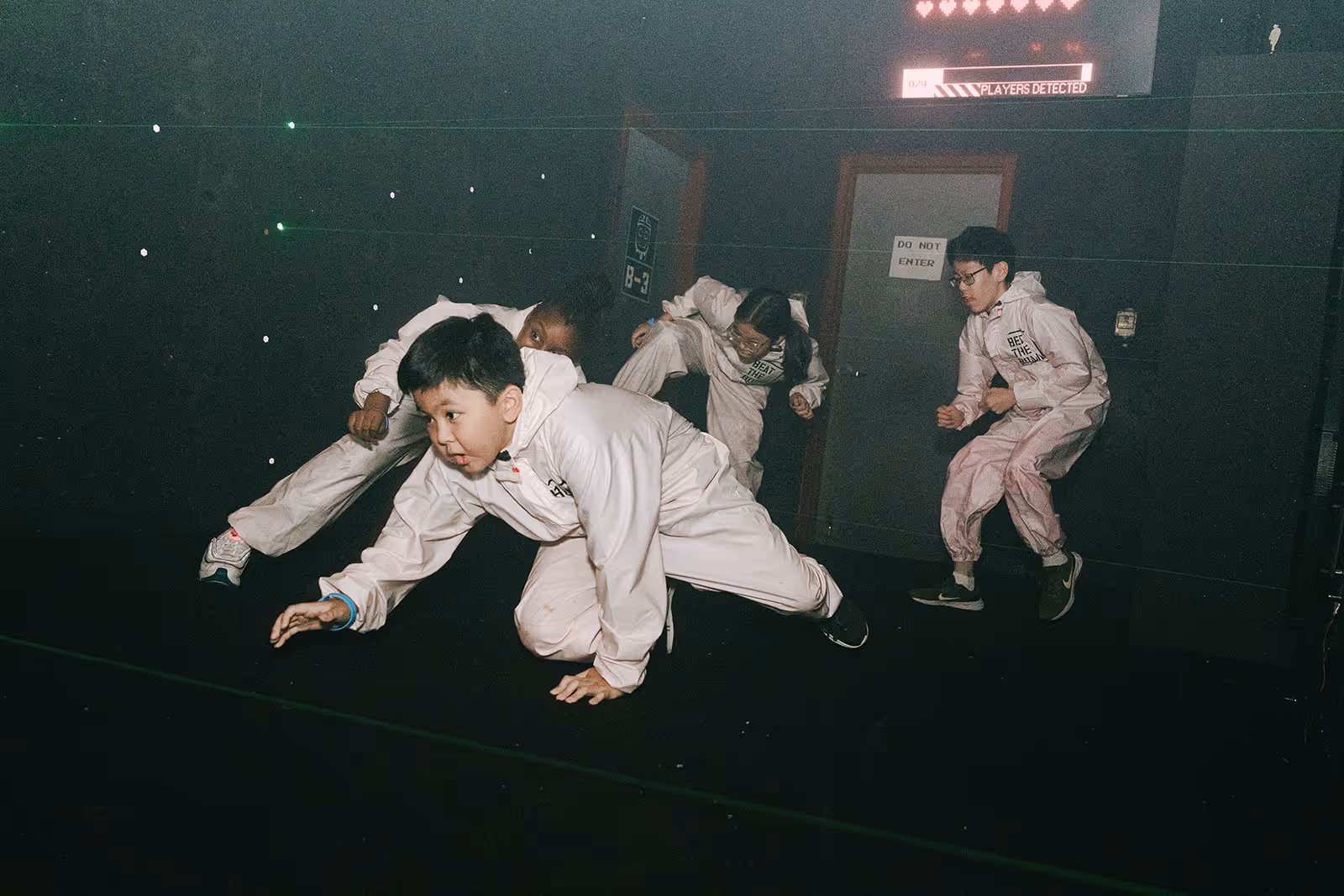 Ka-Boom campers crouching through the laser maze