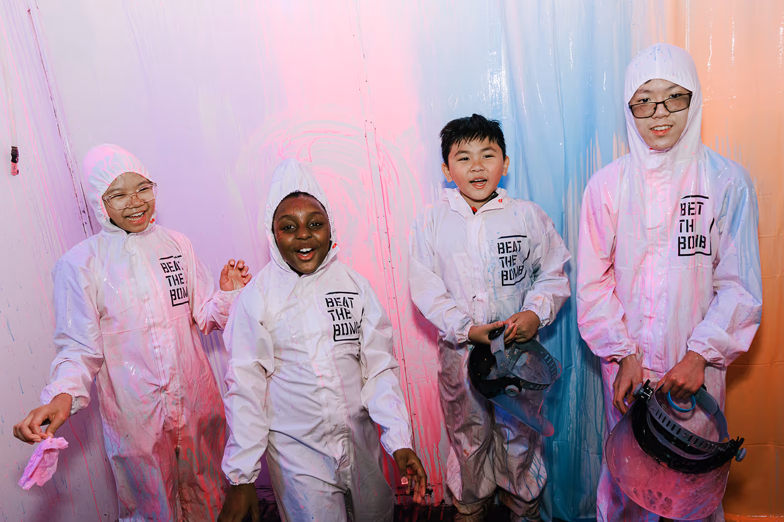 Ka-Boom campers smiling in their hazmat suits after a paint blast