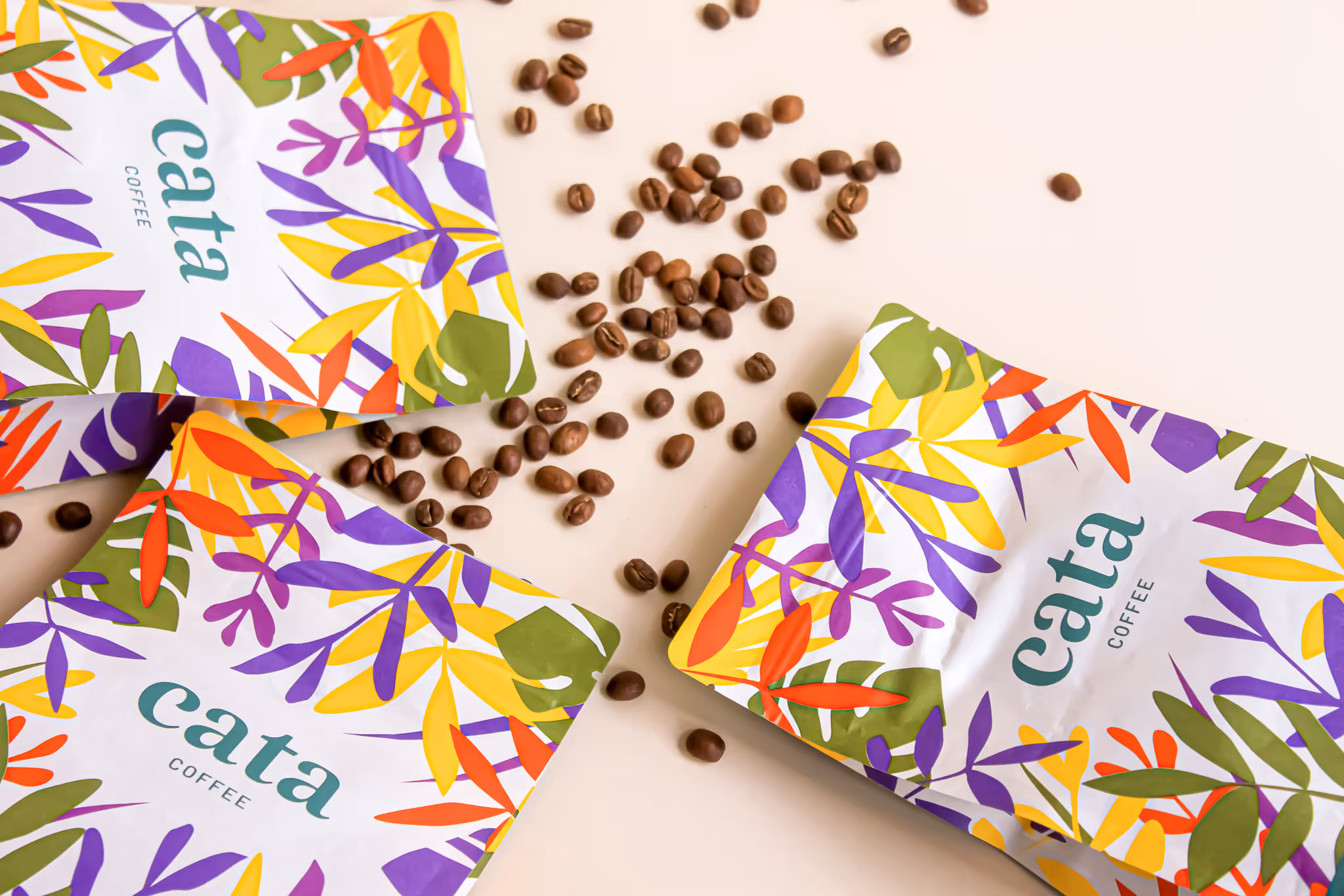 A couple of bags of coffee beans next to a bag of coffee beans
