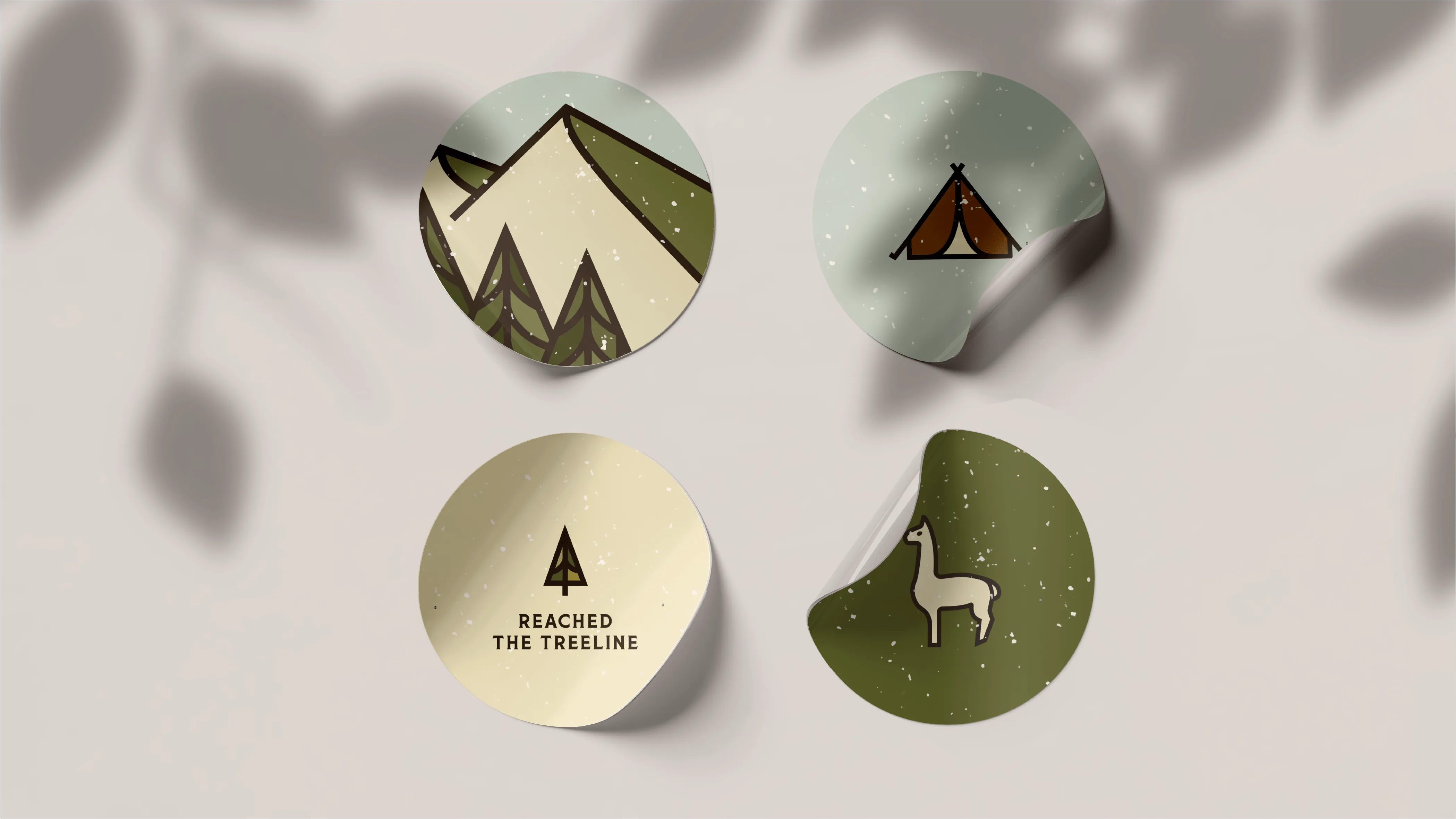 Four stickers with a picture of a mountain and a deer