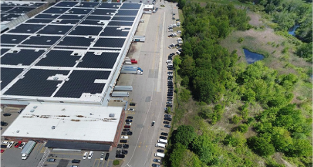 Aerial view of a construction site with steel rebar, wooden planks, pipes, and concrete foundations in progress.