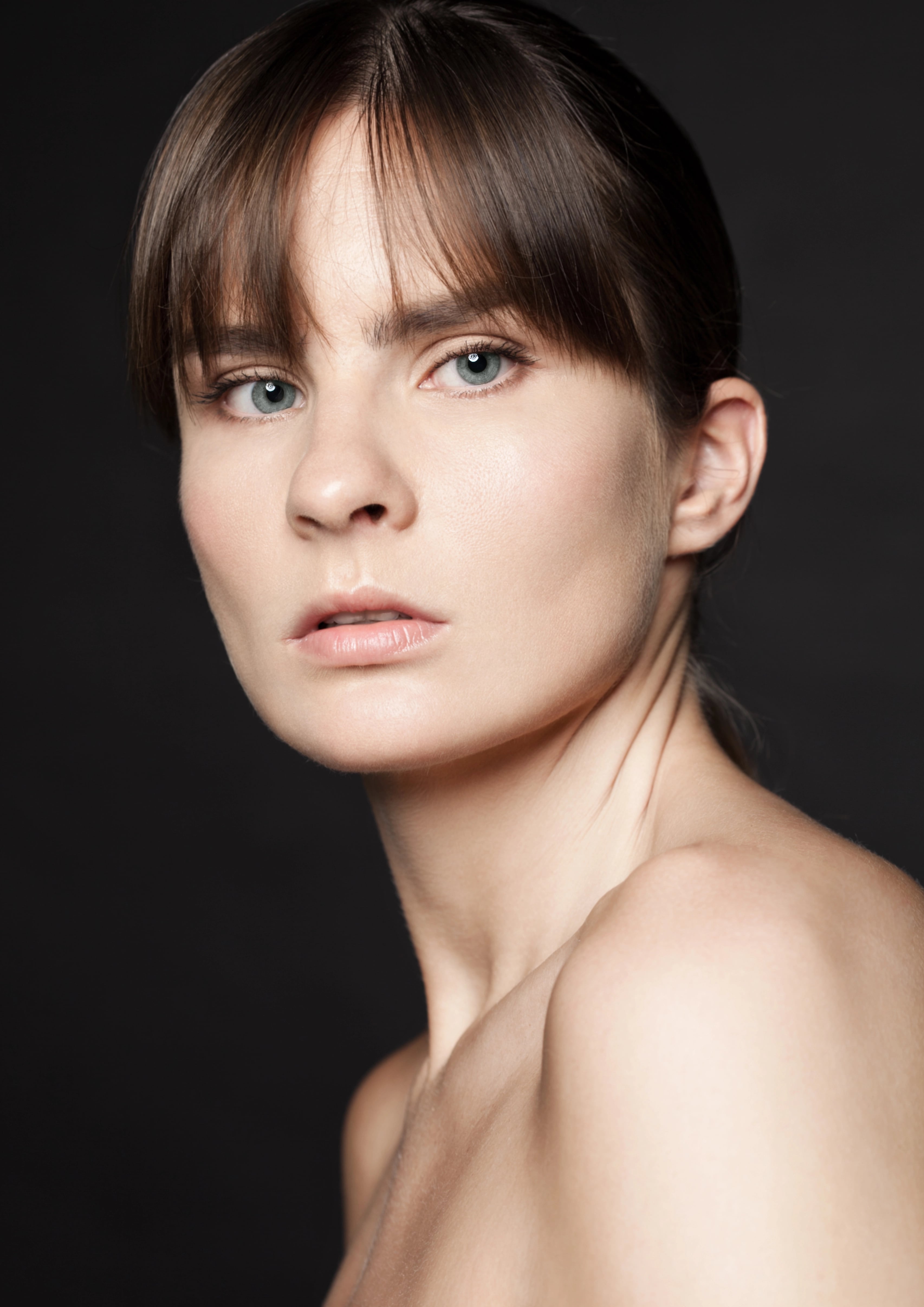 A smiling woman with smooth, glowing skin in a natural wellness setting, representing rejuvenation and aesthetic treatments at a medspa in Hingham, MA.