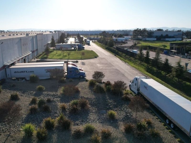 Buske Logistics large distribution center facility showing loading docks and truck activity.