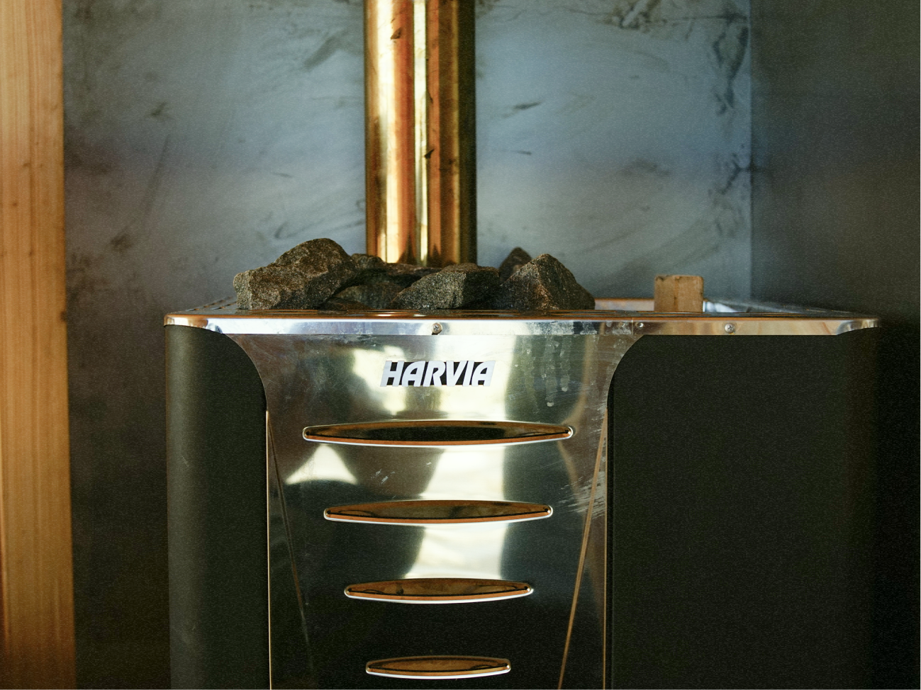 Harvia wood-fired sauna stove with stones and chimney