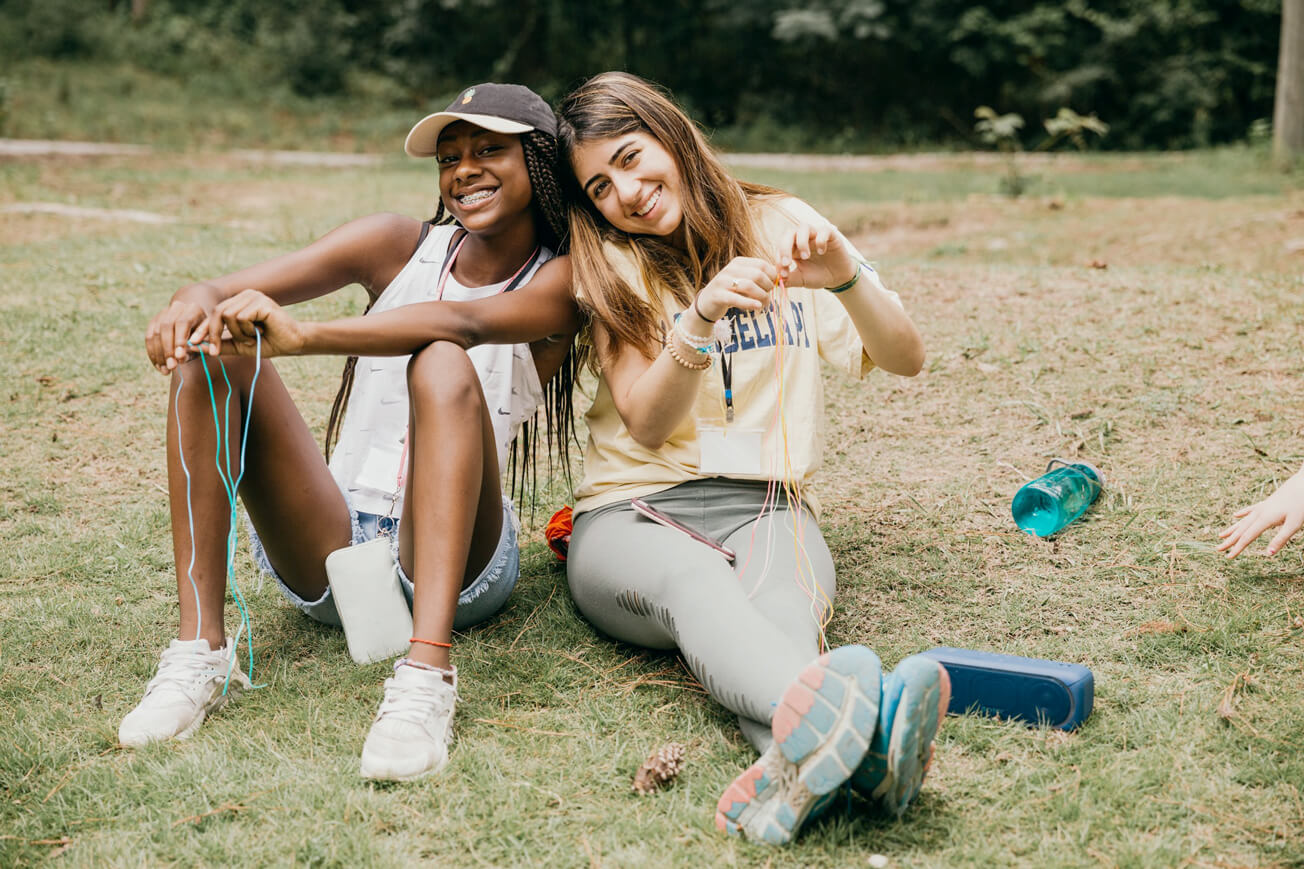 Making friendship bracelets at Camp Kesem