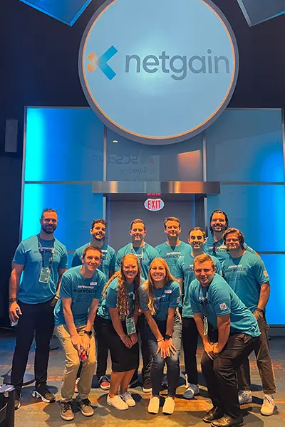 A group of Netgain employees posing for a photo in the High Roller event space.