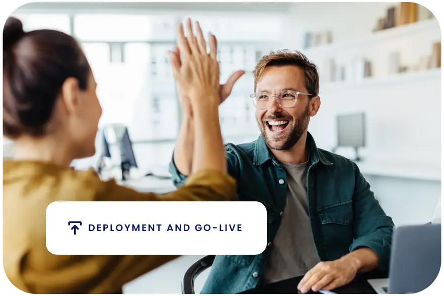 Two professionals high-fiving with the text: Deployment and Go-Live.