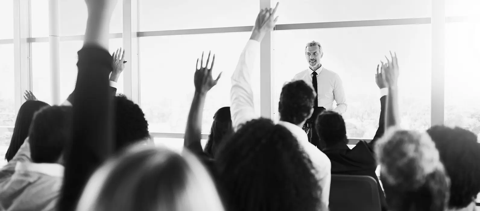 Hands raised to ask questions to presenter