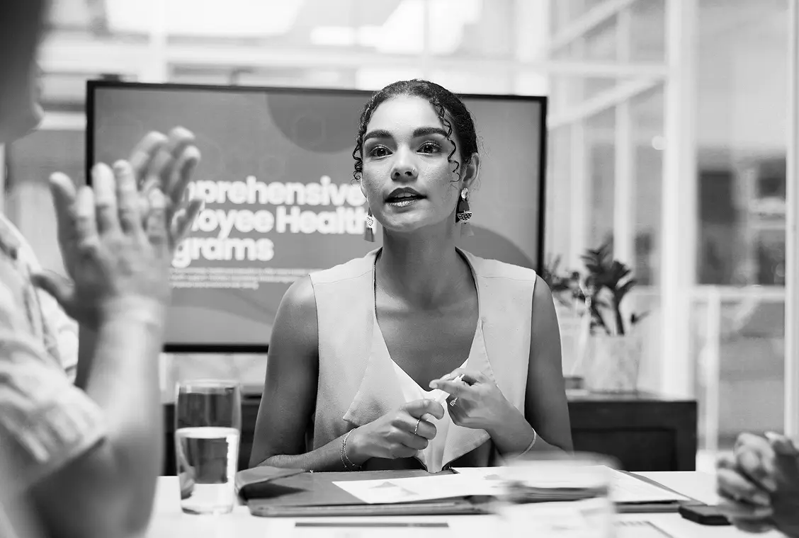 Woman presenting in front of a slide deck