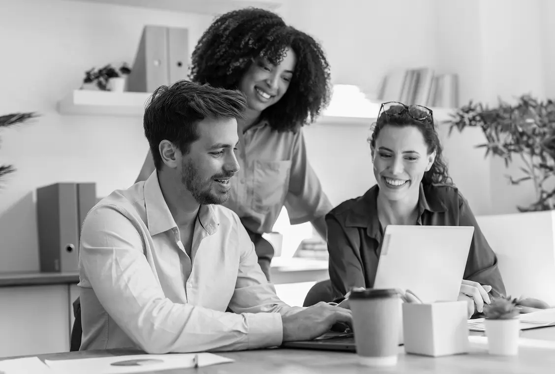 Members looking at a single laptop while working