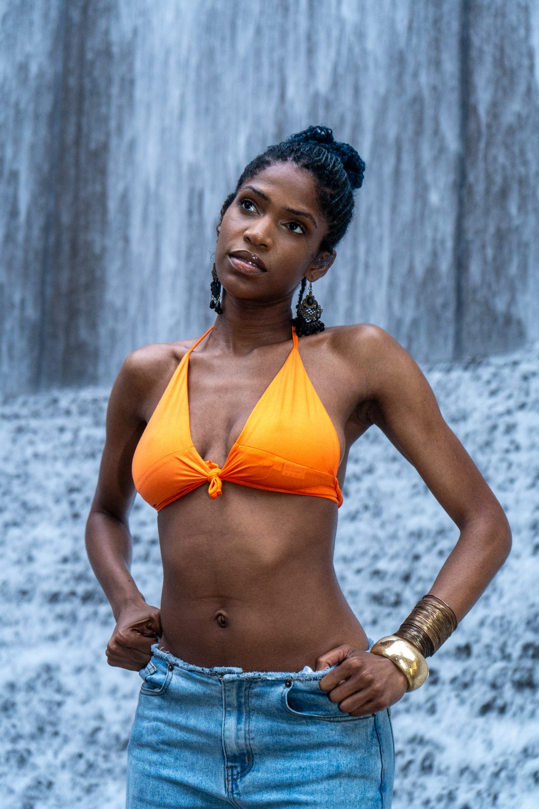 Portrait in orange swimwear against the Houston Waterwall