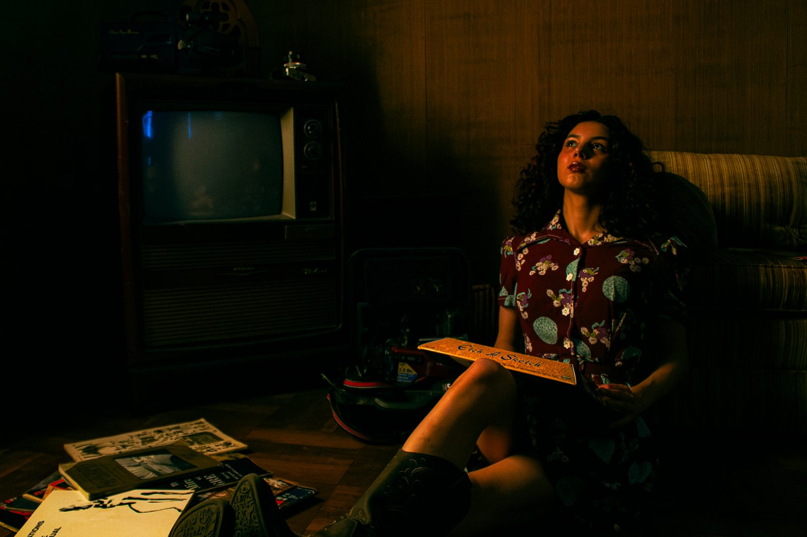 Retro-interior editorial frame, tungsten lamp light and teal shadow