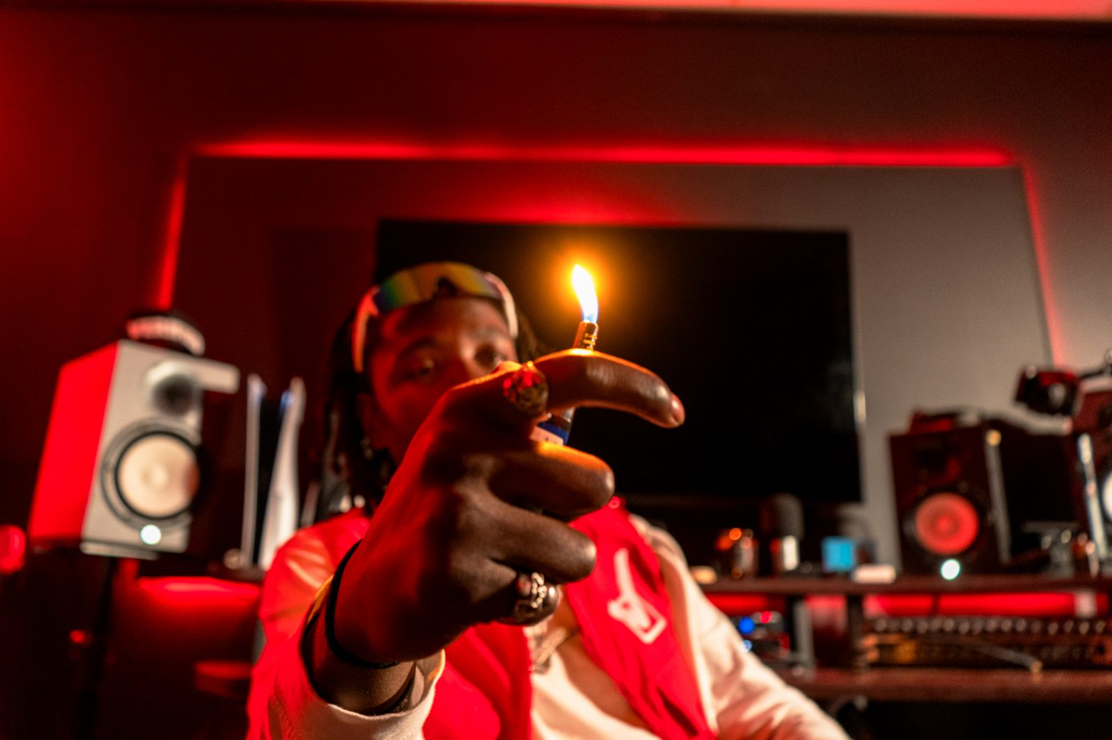 Artist portrait in a red-lit studio control room