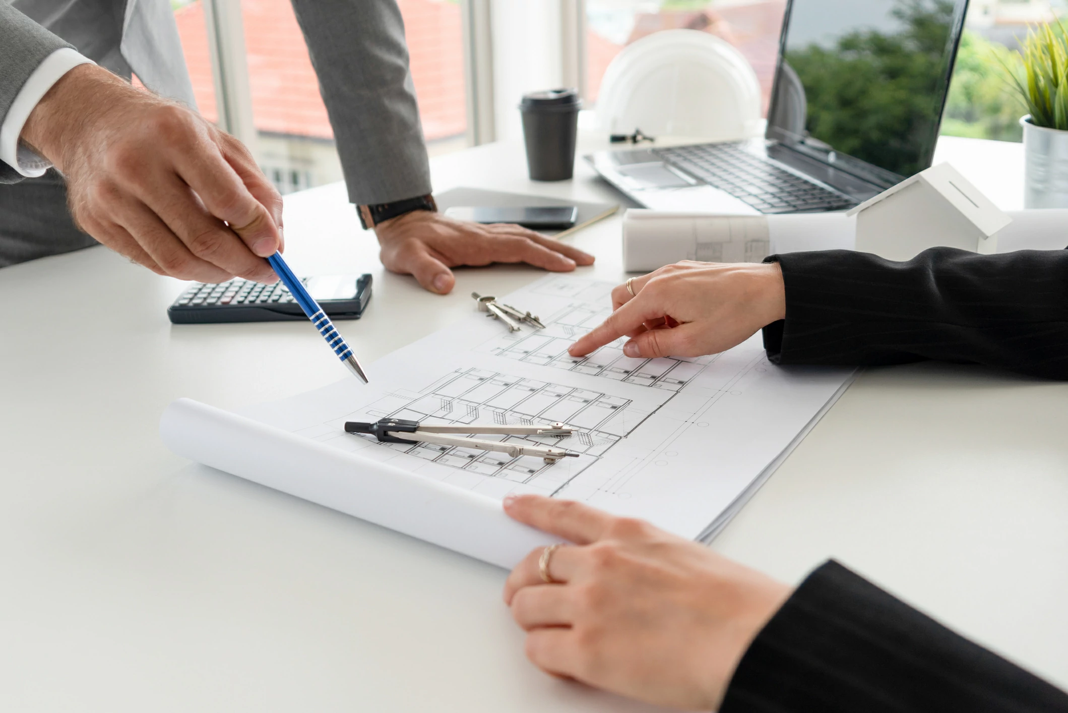 Deux personnes consultant un plan de bâtiment.
