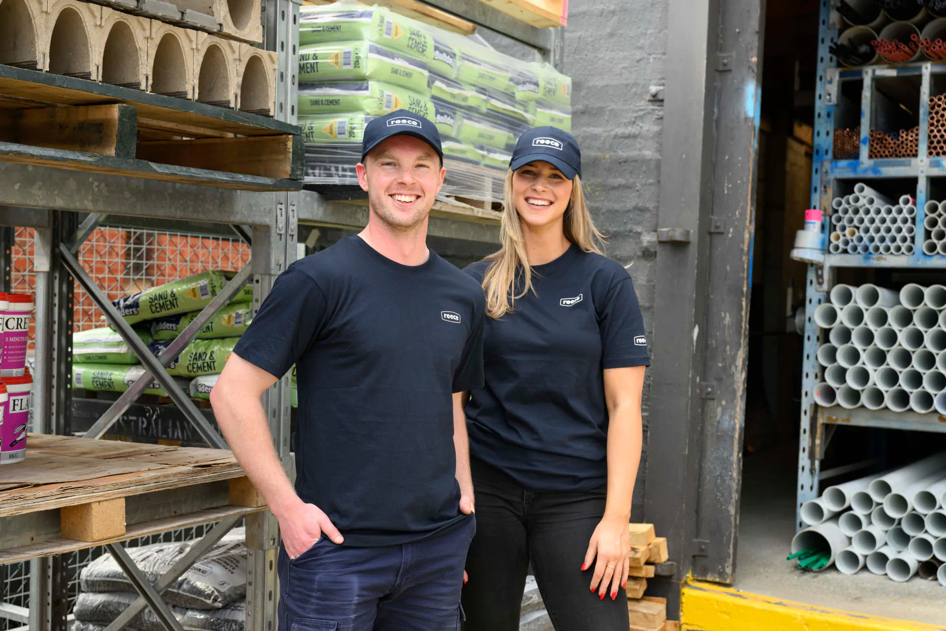 a man and woman wearing black shirts and hats