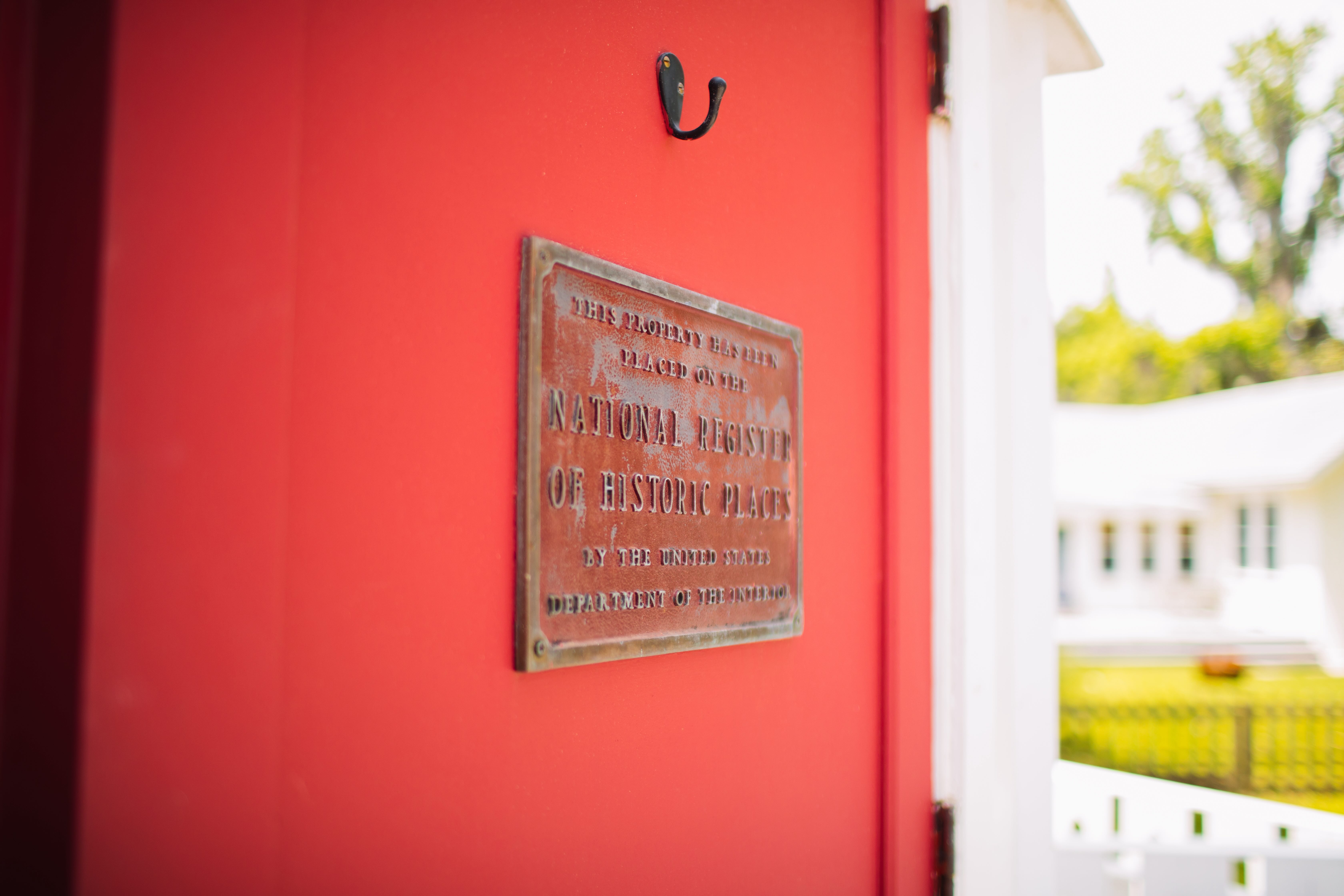 A red door with a sign on it