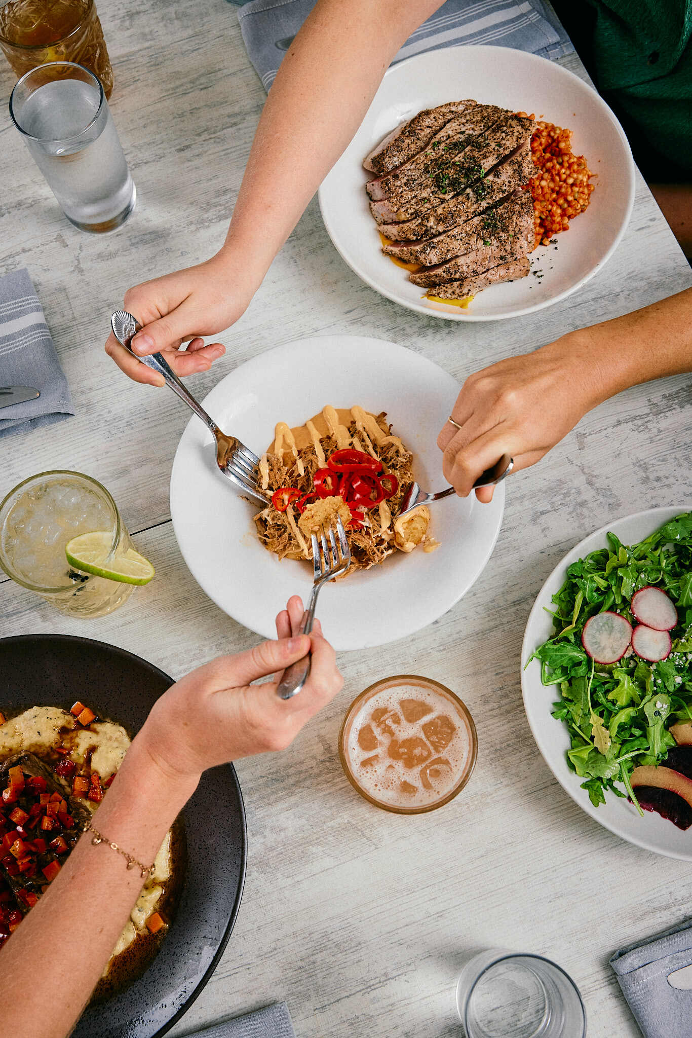 A group of people sitting at a table with plates of food