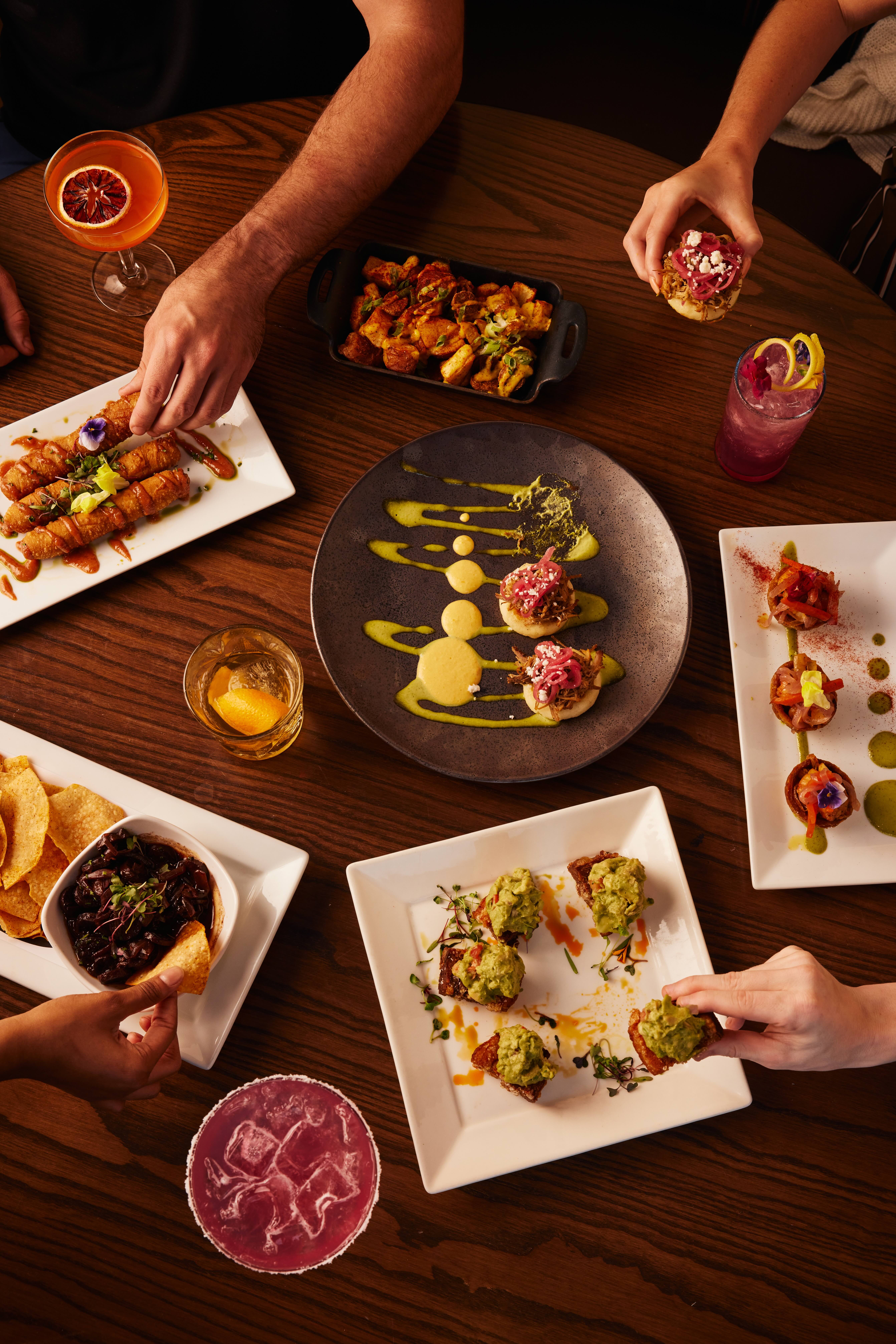 A group of people sitting around a table with plates of food