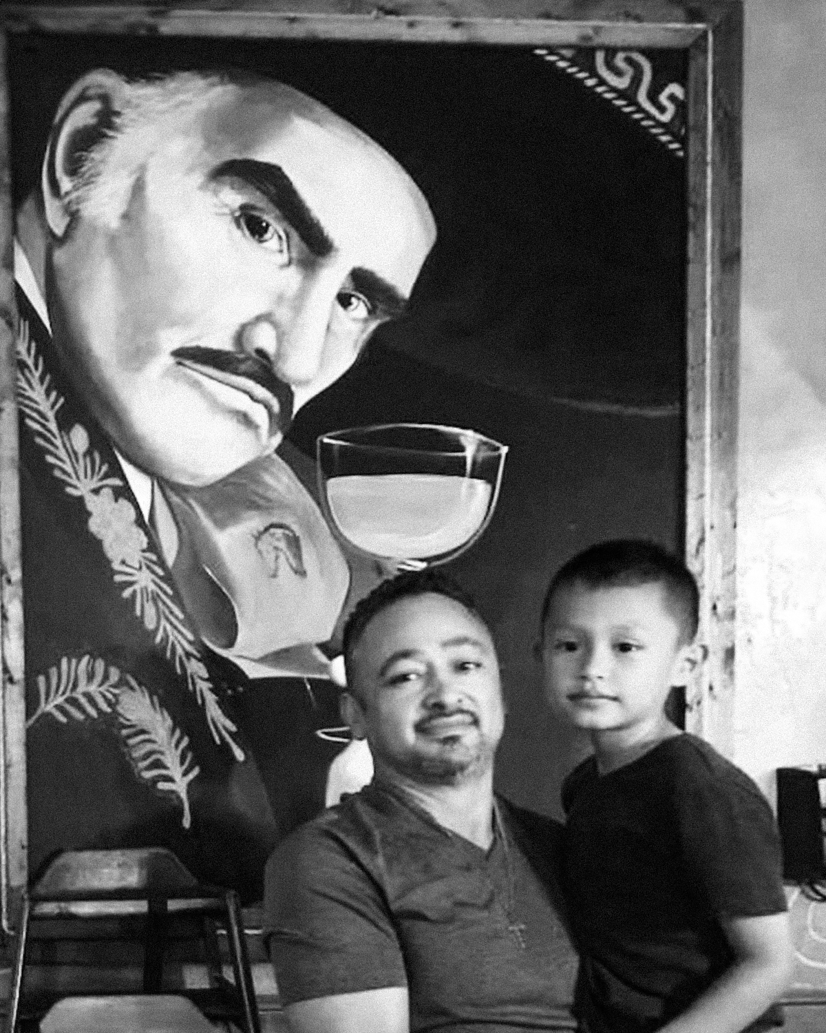 Two guys busy in the kitchen preparing pizza