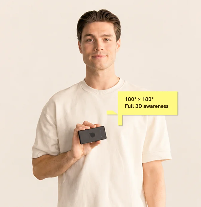 A man at Sonair holding the small ADAR One in his hand, with popup text saying: "180° x 180°, Full 3D awareness"