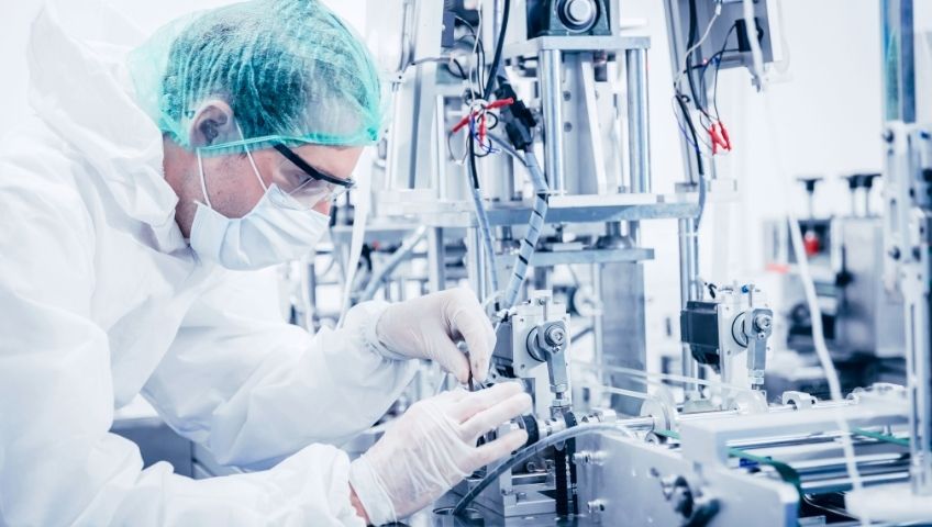 Science worker engineer service advance machine in medical equipment factory.