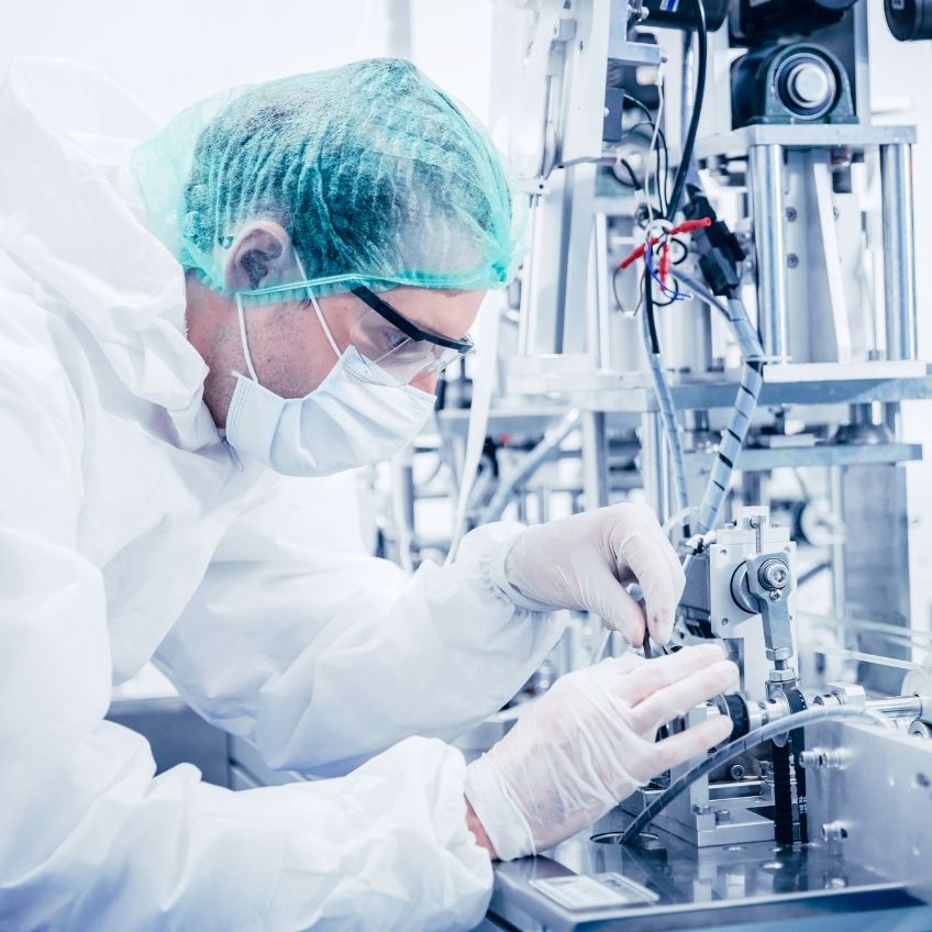 Science worker engineer service advance machine in medical equipment factory.