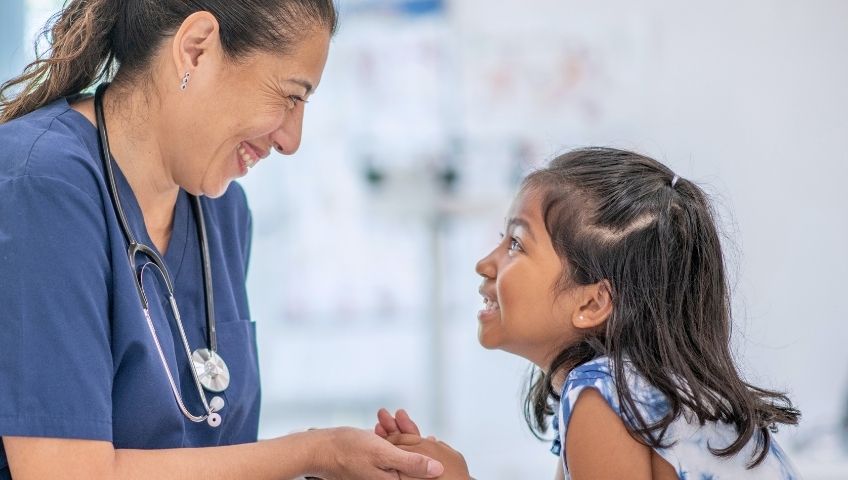 Cute little girl at doctor's office with a nurse