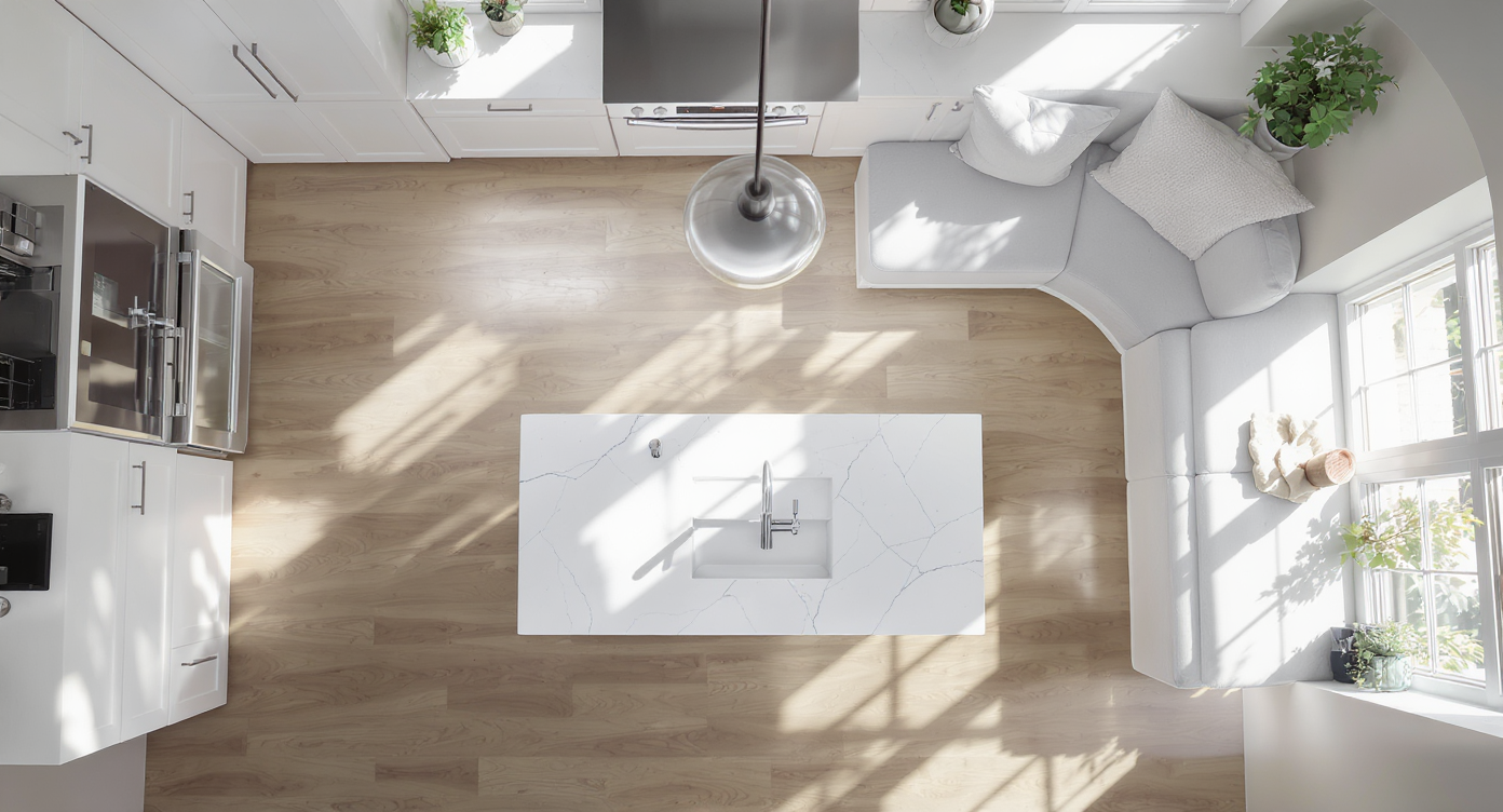 Overhead detailed floor plan of small wall kitchen showing rectangular island and semi-circular breakfast nook with clearance dimensions in neutral tones.