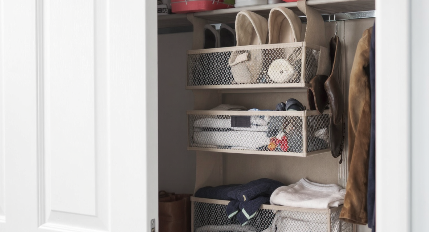Over-the-door storage organizer in a closet holding shoes and accessories for efficient space usage.