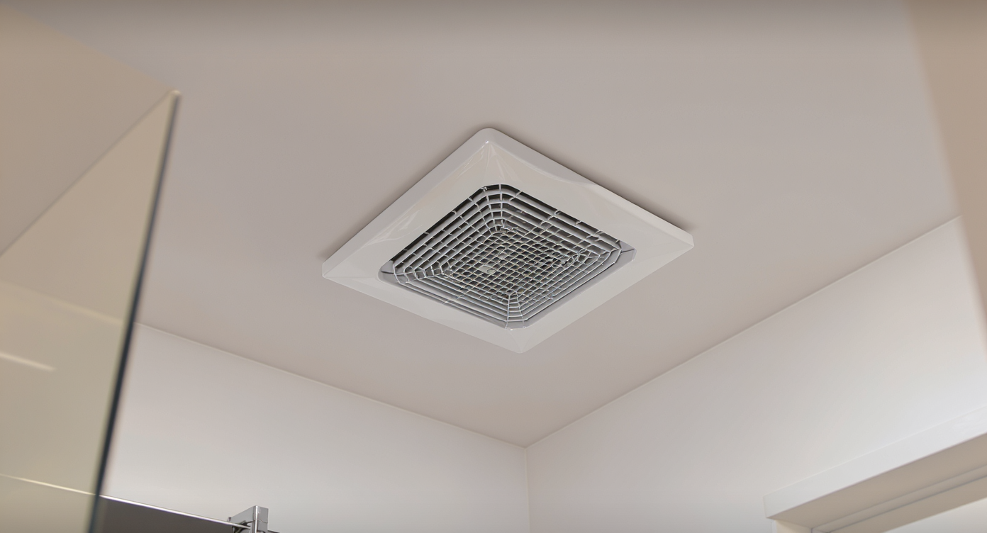 A sleek, modern bathroom featuring a newly installed vent fan, emphasizing both design and functionality.