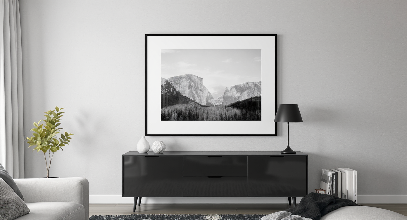 Modern living room with a single black-and-white framed photo above the TV, matching lamp, and uncluttered wall for a refined, cohesive look.